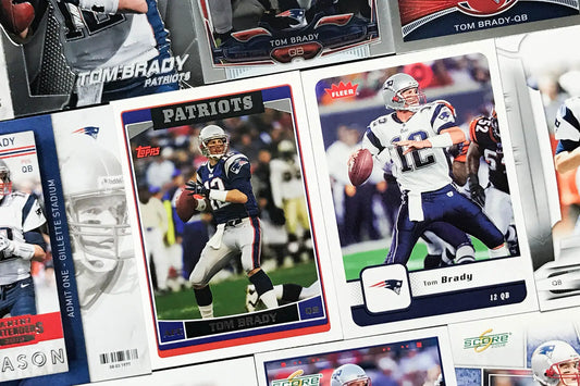 Collection of New England Patriots football trading cards including Tom Brady rookie cards.