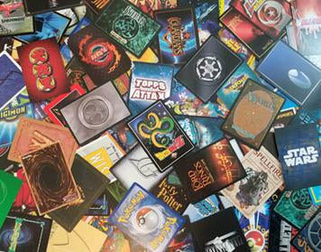 Collection of trading cards from games like Star Wars and Pokemon in an article on trading card games