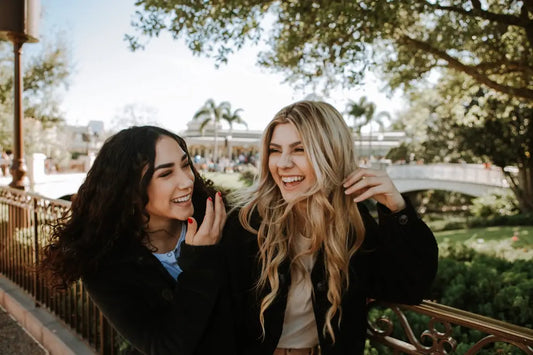 Two friends laughing outdoors showcasing the joy of sportscards as unique investments